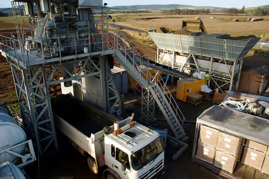 Used batching plant loading into truck mixer below